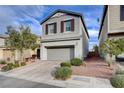 Two-story house with gray siding, shutters, and a landscaped yard at 7960 Brookside Falls Ct, Las Vegas, NV 89166