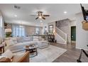 Spacious living room with sectional sofa, fireplace, and hardwood floors at 7960 Brookside Falls Ct, Las Vegas, NV 89166