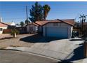 Single-story house with tile roof, attached garage, and a driveway at 8072 Hackberry Dr, Las Vegas, NV 89123