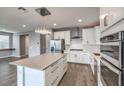 Modern kitchen with white cabinets, island, and stainless steel appliances at 8130 Skye Sweep St, Las Vegas, NV 89166