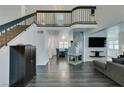 Two-story living room with a fireplace, high ceilings, and gray sectional sofa at 8424 Oyster Dr, Las Vegas, NV 89128