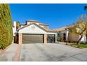 Two-story house with a three-car garage and landscaped front yard at 8466 Lambert Dr, Las Vegas, NV 89147