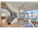 Open living space with a staircase, hardwood floors, and backyard view at 8466 Lambert Dr, Las Vegas, NV 89147