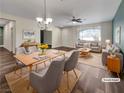 Virtually staged dining room with light wood table and gray chairs at 866 Austin Peak Ct, Las Vegas, NV 89110