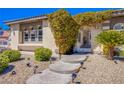 Inviting front entrance with a walkway and lush landscaping at 8965 S Tenaya Way, Las Vegas, NV 89113