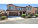 Two-story house with brown garage doors and green shutters at 9221 Black Lake Pl, Las Vegas, NV 89178