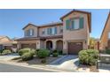 Two-story house with brown garage doors and green shutters at 9221 Black Lake Pl, Las Vegas, NV 89178