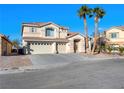 Two-story house with three-car garage and palm trees at 9307 Bondeno St, Las Vegas, NV 89123