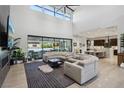 Open living space with sectional sofa, kitchen views, and high ceilings at 103 San Martino Pl, Henderson, NV 89011