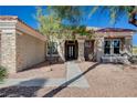 Inviting home entrance featuring stone accents and manicured landscaping at 10300 Bent Brook Pl, Las Vegas, NV 89134