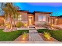 Beautiful home exterior with landscaping and lighting at 116 Stone Mesa Ct, Henderson, NV 89011