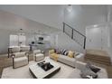 Open concept living room with modern staircase and kitchen view at 1881 Citroen St, Las Vegas, NV 89142