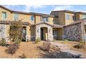 Tan townhome with stone accents and a walkway leading to the entrance at 3272 Palindrome Ave, Henderson, NV 89044