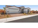 A beautiful home with a brick driveway and a two-car garage surrounded by desert landscaping at 4540 S Pienza Ct, Pahrump, NV 89061