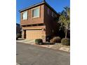 Two-story house with attached garage and light brown exterior at 616 Taliput Palm Pl, Henderson, NV 89011