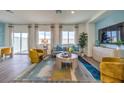 Bright living room featuring a comfortable sofa, accent chairs, and a large TV at 7850 Pandora Sky St # 212, North Las Vegas, NV 89084