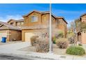 Two-story house with attached garage and mature shrubs at 9204 Weeping Hollow Ave, Las Vegas, NV 89178