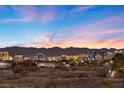 Panoramic city view showcasing the illuminated skyline against a colorful evening sky at 9605 Verlaine Ct, Las Vegas, NV 89145