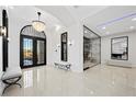 Stunning foyer with a grand entrance, decorative lighting, marble floors, and views of the wine cellar at 9605 Verlaine Ct, Las Vegas, NV 89145