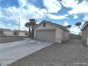 Attached garage with a single door and gravel driveway at , North Las Vegas, NV 89031