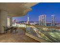 Night view from a condo balcony featuring city lights and a table with chairs at 2777 Paradise Rd # 2001, Las Vegas, NV 89109