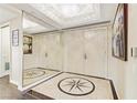 Elegant entryway with a large mirror, double doors, and compass-design tile floor at 2777 Paradise Rd # 2001, Las Vegas, NV 89109