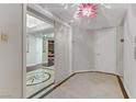 Condo hallway with mirror reflecting a room and a pink chandelier at 2777 Paradise Rd # 2001, Las Vegas, NV 89109