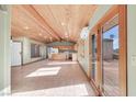 Open kitchen with wood ceilings, tile floors, and access to a deck at 3281 Mark Rd, Pahrump, NV 89060