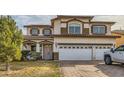 Two-story house with a two-car garage and landscaped front yard at 394 Gatlinburg Ct, Henderson, NV 89012