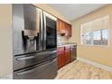 Stainless steel refrigerator in galley kitchen at 5098 River Glen Dr # 220, Las Vegas, NV 89103
