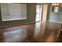 Living room with hardwood floors and a large window at 6681 Bubbling Brook Dr # A, Las Vegas, NV 89107