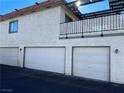 Attached garage with two garage doors and a balcony above at 1009 Willow Tree Dr # C, Las Vegas, NV 89128