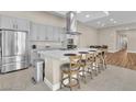 Spacious kitchen featuring stainless steel appliances, gray cabinets, a large island with seating, and tile flooring at 10301 Fairview Ridge Ct, Las Vegas, NV 89166