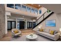 Bright living room with high ceilings, skylights, hardwood floors, and a view of the staircase at 1630 Westwood Dr, Las Vegas, NV 89102