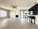 Spacious living room with a fireplace, ceiling fan, and sliding glass doors that flood the room with natural light at 2600 Congress Ave, Las Vegas, NV 89121