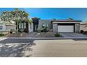 Modern two-toned house with attached garage and desert landscaping at 4829 E Beacon Ridge Dr, Pahrump, NV 89061
