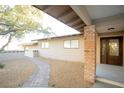 Ranch style home with brick columns, landscaped walkway, and mature tree at 749 Rossmore Dr, Las Vegas, NV 89110