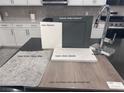 Kitchen design featuring gray cabinets, white quartz countertops, and gray flooring at 9132 Vesey Ave, Las Vegas, NV 89148