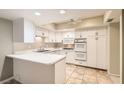 Well-equipped kitchen with white cabinets and tile flooring at 3624 Townsend St, Las Vegas, NV 89121