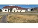 House exterior showcasing a large front yard and walkway at 390 China St, Pahrump, NV 89048