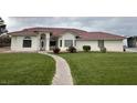 A beautiful single-story home with stucco exterior, tile roof, and well-manicured lawn at 390 China St, Pahrump, NV 89048
