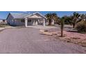 Single-story house with carport and desert landscaping at 5271 Deanna St, Pahrump, NV 89048