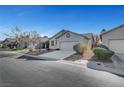 Street view of a well-maintained single-story house featuring desert landscaping and a two-car garage at 5919 Pavilion Lakes Ave, Las Vegas, NV 89122