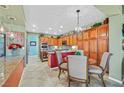 Eat-in kitchen with granite countertops and wooden cabinets at 7152 Royal Melbourne Dr, Las Vegas, NV 89131