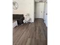 Living room showcasing gray couch and wood-look flooring at 929 Rockview Dr # 202, Las Vegas, NV 89128