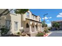 Townhouse exterior with arched entryway and landscaping at 12064 Avery Meadows Ave, Las Vegas, NV 89138