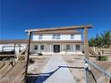 Two-story house with walkway and wooden gate at 1590 Mustang Dr, Henderson, NV 89002