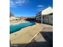 Inviting kidney-shaped pool with concrete decking at 1590 Mustang Dr, Henderson, NV 89002
