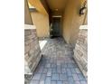 Inviting entrance with beautiful stone pillars and brick paved walkway at 181 Elexese Ct, Las Vegas, NV 89183