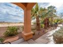 Landscaped backyard with palm trees and walkway at 2520 Links Dr, Laughlin, NV 89029